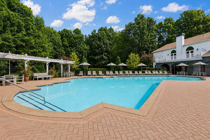 Landscaped pool area with outdoor seating at Avana TownPark apartments in Kennesaw, GA