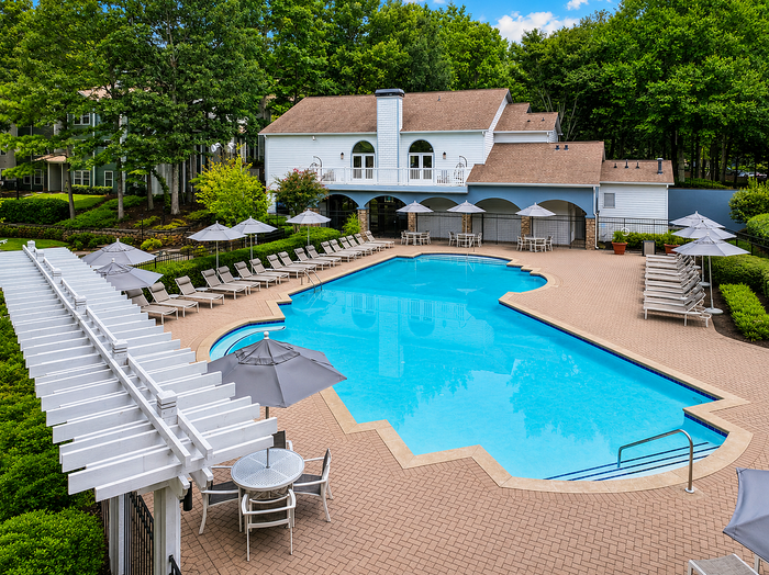 Drone view of the swimming pool, pool deck and lounge seating at Avana TownPark apartments in Kennesaw, GA