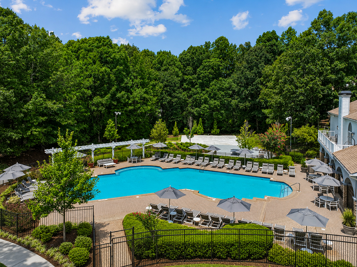 Outdoor swimming pool with lounge seating at Avana TownPark apartments in Kennesaw, GA