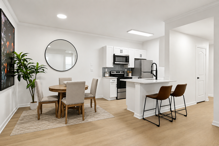 Diamond renovation apartment kitchen and dining area with white cabinetry and stainless steel appliances at Avana TownPark in Kennesaw, GA