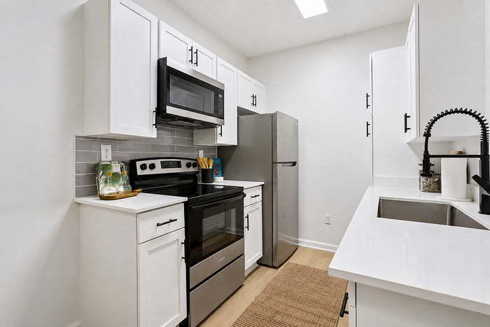 Diamond renovation kitchen with white cabinetry, stainless steel appliances and quartz countertops at Avana TownPark in Kennesaw, GA
