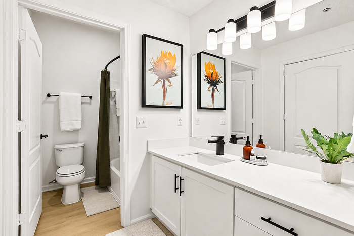 Diamond renovation bathroom with white vanity and matte black fixtures at Avana TownPark in Kennesaw, GA