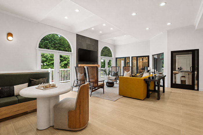 Clubhouse lounge with comfortable seating, television and social gathering space at Avana TownPark in Kennesaw, GA