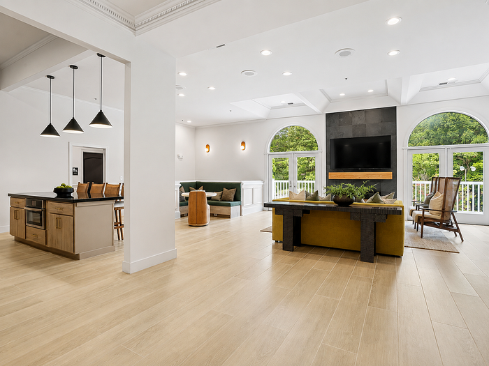 Resident clubhouse with community kitchen, island seating and lounge area at Avana TownPark in Kennesaw, GA