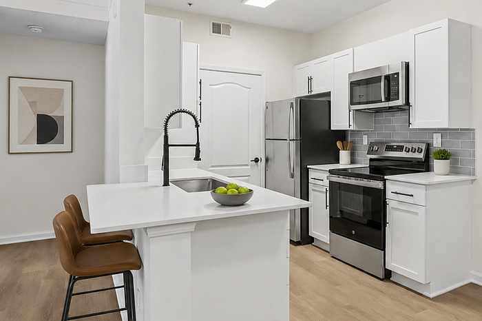 Contemporary kitchen with sleek white cabinetry, stainless steel appliances, and elegant island seating.