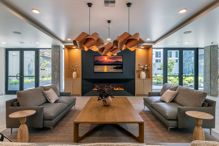Luxurious modern living room with elegant lighting, stylish sofas, and a cozy fireplace, perfect for relaxation and entertainment.