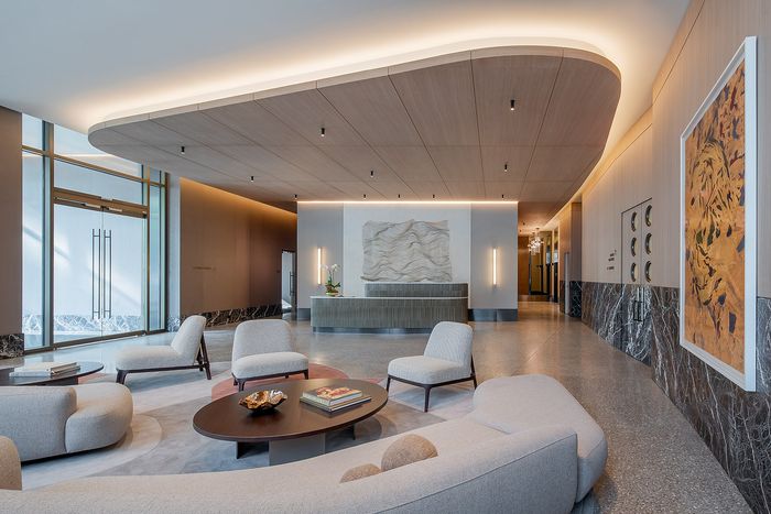 Sophisticated apartment lobby with modern furnishings, sleek lighting, and elegant decor creating a welcoming atmosphere.