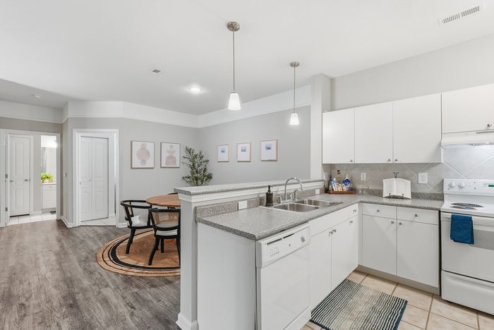 Modern kitchen and dining area with sleek countertops, stylish lighting, and elegant decor creating a welcoming atmosphere.