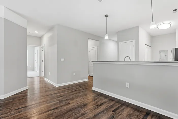 Elegant modern entryway with warm wood floors and soft lighting creating a welcoming ambiance.