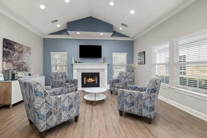 Elegant living room featuring modern blue accents, a cozy fireplace, and stylish patterned seating, perfect for relaxation and entertaining.