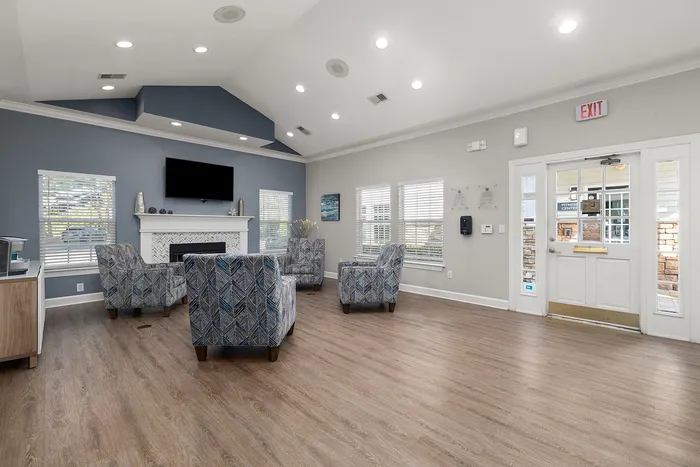 Inviting lounge area with elegant seating, modern fireplace, and abundant natural light.