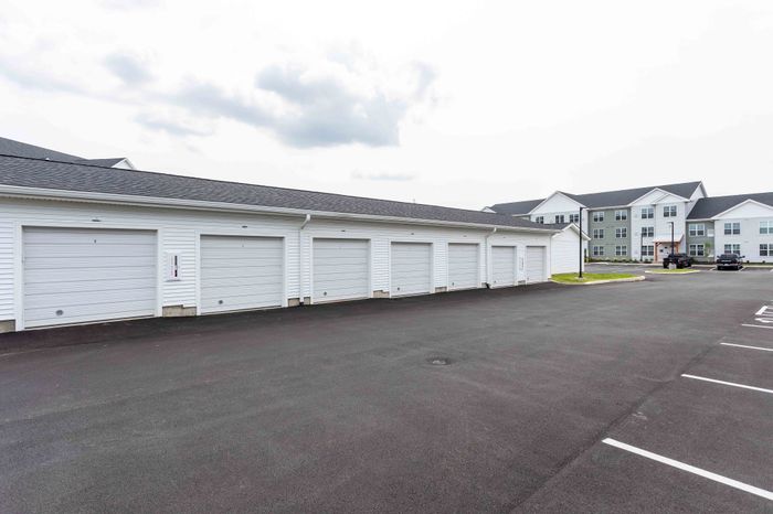 Modern apartment complex with convenient private garages and ample parking space.