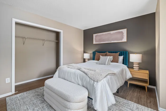 Chic bedroom featuring a plush bed with textured blankets, modern nightstands, and ambient lighting, offering a cozy and stylish retreat.