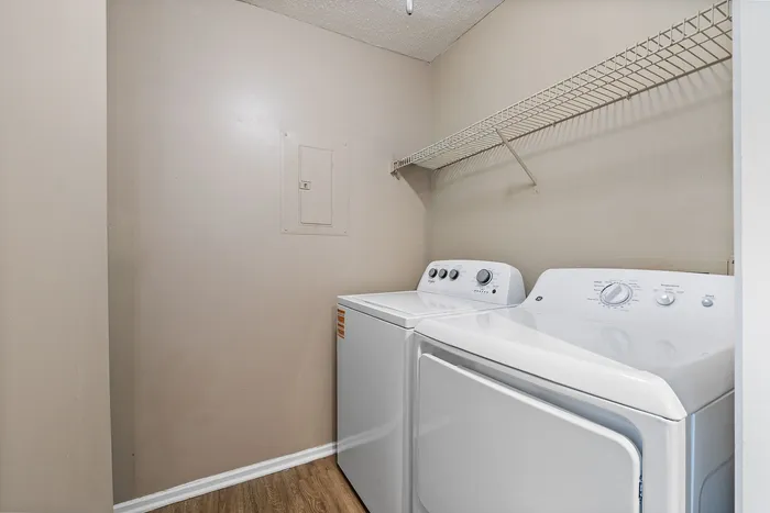 Efficient laundry room featuring modern washer and dryer with plenty of storage space.