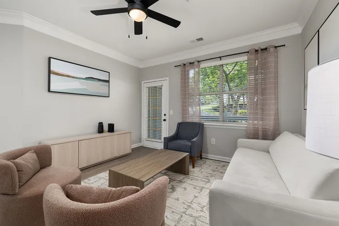 Bright and inviting living room with modern furniture, stylish decor, and large windows providing ample natural light.