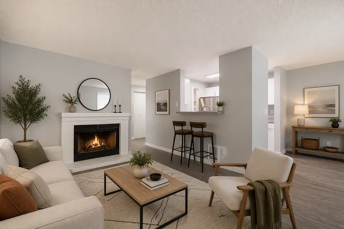 Inviting living room with modern fireplace, cozy seating, and a stylish open-concept kitchen bar area.