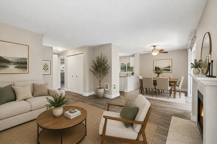 Inviting open-concept living space with elegant decor, featuring a cozy sitting area, dining table, and modern kitchen, perfect for entertaining.
