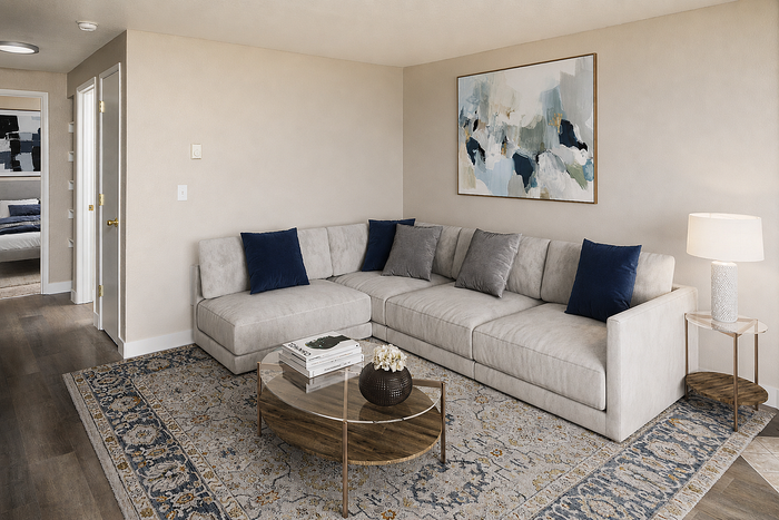 Chic living room with elegant gray sofa, modern art, and a stylish coffee table creating a cozy ambiance.