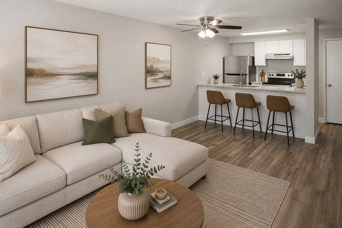 Modern open-concept living room with elegant decor, cozy sectional sofa, and a sleek kitchen with stylish bar stools, perfect for entertaining.