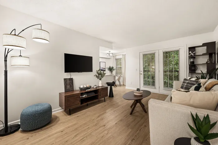 Bright and inviting living room featuring stylish decor, large windows, and a cozy seating area, perfect for relaxation and entertaining.