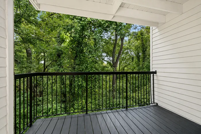 Serene balcony retreat surrounded by lush greenery, offering peaceful views and relaxation.