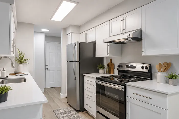 Modern kitchen showcasing sleek stainless steel appliances, white cabinetry, and elegant countertops for a stylish cooking experience.