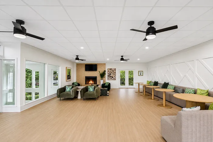 Spacious and inviting community lounge with modern seating, cozy fireplace, and elegant decor, perfect for relaxing and entertaining.