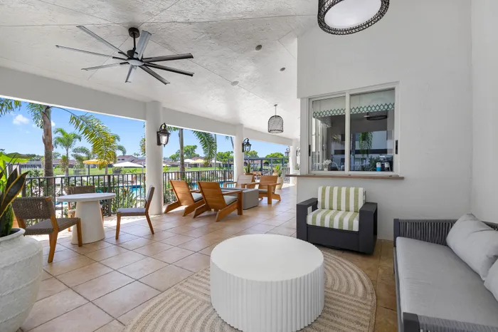 Inviting covered patio with elegant seating and tropical views, ideal for relaxing or entertaining.