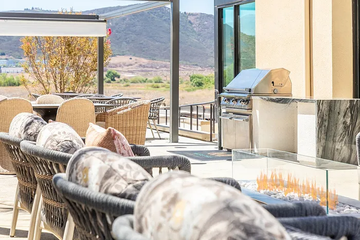 Luxurious outdoor patio with stylish seating, modern grill, and scenic mountain views for perfect entertaining.