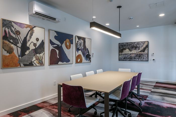 Contemporary meeting room with stylish abstract art and vibrant seating, perfect for productive gatherings.