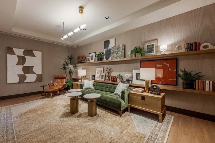 Stylish community library with elegant lighting, modern art, plush seating, and chic decor creating a cozy and inviting atmosphere.