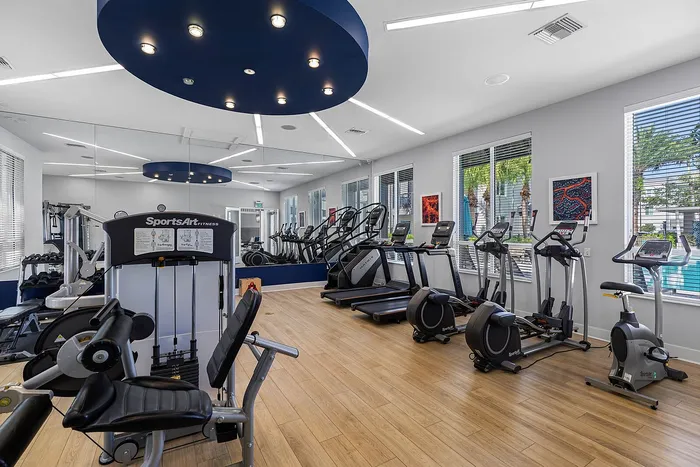 Modern fitness center with state-of-the-art equipment, sleek design, and bright natural lighting.