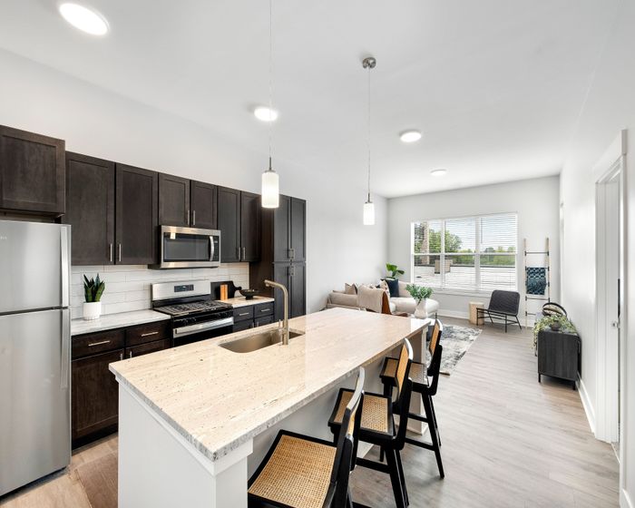 Open-plan kitchen with island and breakfast bar seating
