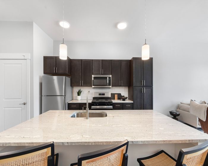 Open-plan kitchen with island and breakfast bar seating