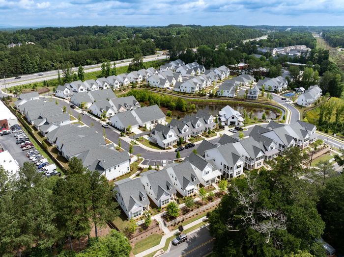 Charming suburban neighborhood with modern homes surrounded by lush greenery, offering a peaceful living environment.