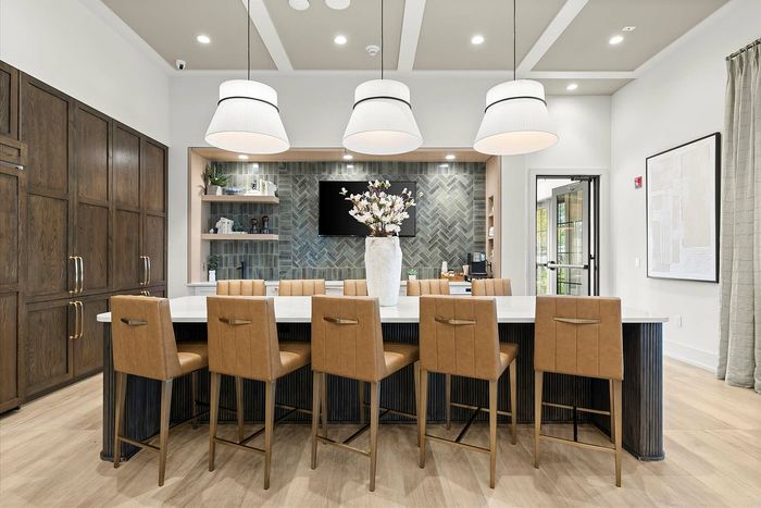 Elegant kitchen space featuring a modern island with stylish bar stools, pendant lighting, and a sleek backsplash for a sophisticated touch.