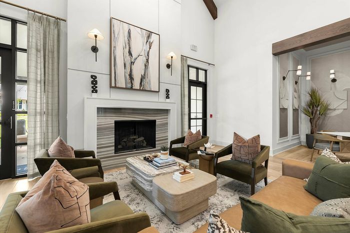 Luxurious living room featuring elegant seating, a modern fireplace, and stylish decor creating a warm, inviting atmosphere.