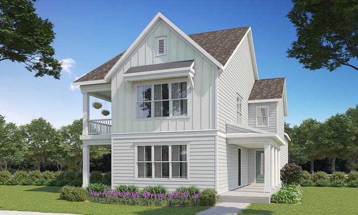 Charming two-story white house surrounded by lush greenery, featuring a welcoming porch and elegant architectural details.