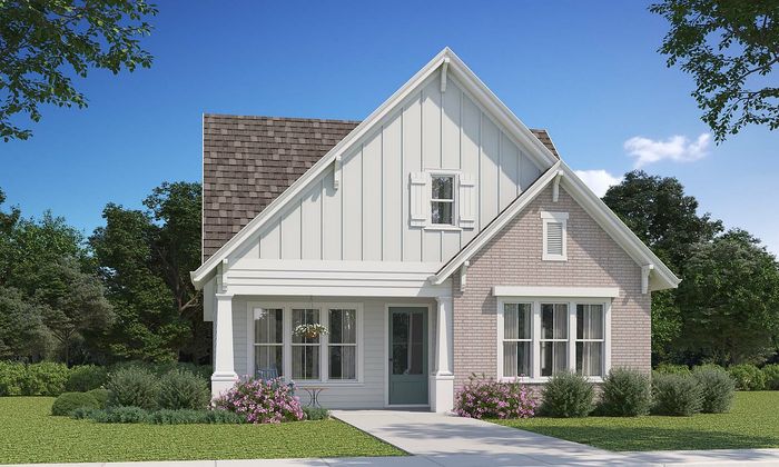 Charming modern cottage with a picturesque front garden and classic gable roof, nestled in a serene setting.