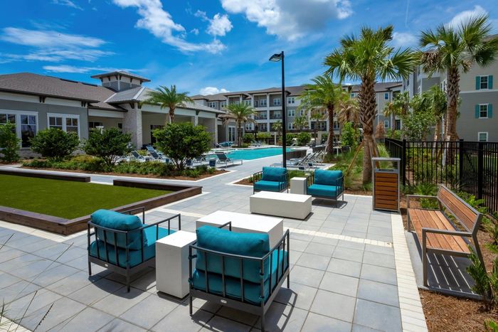 Outdoor lounge at our 55 and over apartments in Winter Garden, FL, featuring outdoor furniture and a pool.