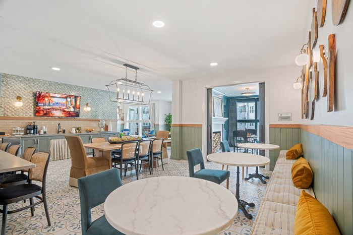 Charming dining area with elegant tables and cozy seating, featuring contemporary decor and abundant natural light.
