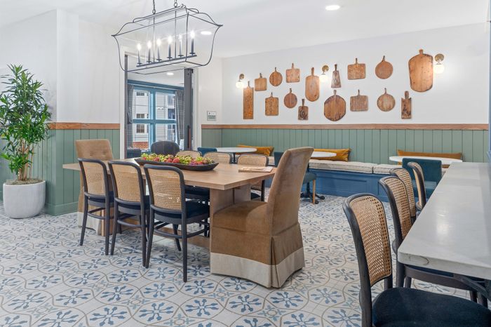 Charming dining area with rustic decor, featuring a large wooden table, comfortable chairs, and unique wall art, perfect for family gatherings.