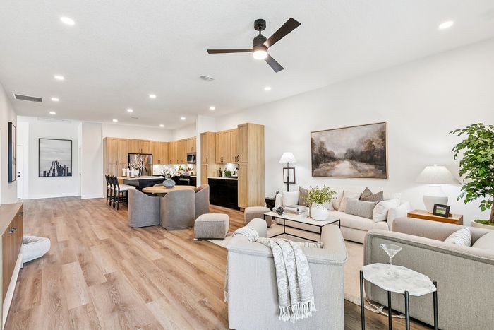 Elegant open-concept living space featuring modern kitchen, cozy seating area, and stylish decor with abundant natural light.