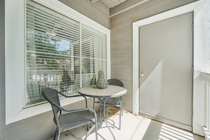 Charming patio with elegant seating and decorative table, perfect for relaxing and enjoying serene views.