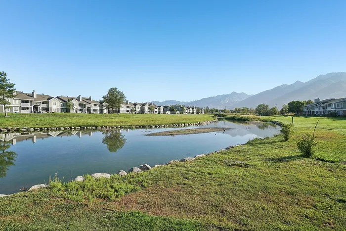 Stunning lakeside apartments with breathtaking mountain views and lush green surroundings.
