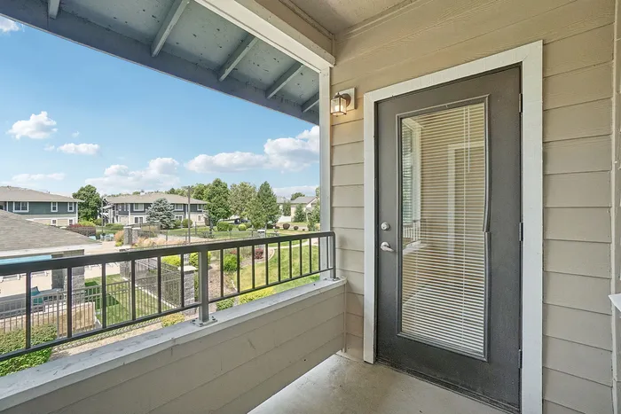 Charming balcony view featuring lush greenery and serene surroundings, perfect for enjoying sunny days.