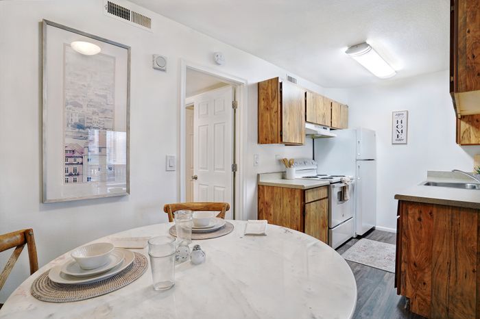 Charming kitchen with modern white appliances and a cozy dining nook.