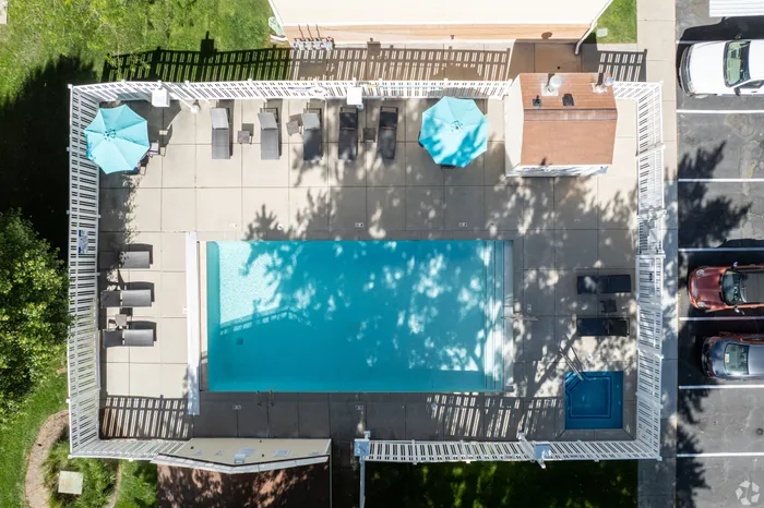 Aerial view of outdoor swimming pool with surrounding lounge chairs.