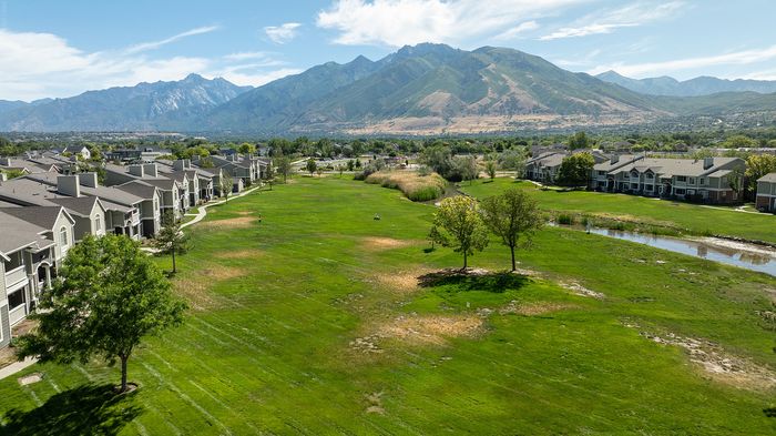 Charming community with scenic views of lush green spaces and majestic mountains, perfect for tranquil living.