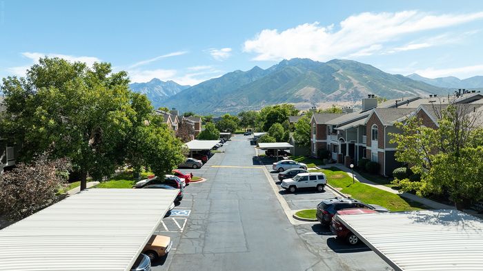 Charming residential neighborhood with tree-lined streets, ample parking, and mountain views creating a serene atmosphere.